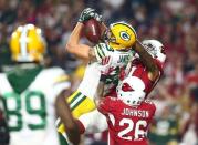 Jan 16, 2016; Glendale, AZ, USA; Green Bay Packers wide receiver Jeff Janis (83) catches a hail mary pass for a touchdown against Arizona Cardinals cornerback Patrick Peterson (21) and free safety Rashad Johnson (26) during the fourth quarter in a NFC Divisional round playoff game at University of Phoenix Stadium. Mandatory Credit: Mark J. Rebilas-USA TODAY Sports