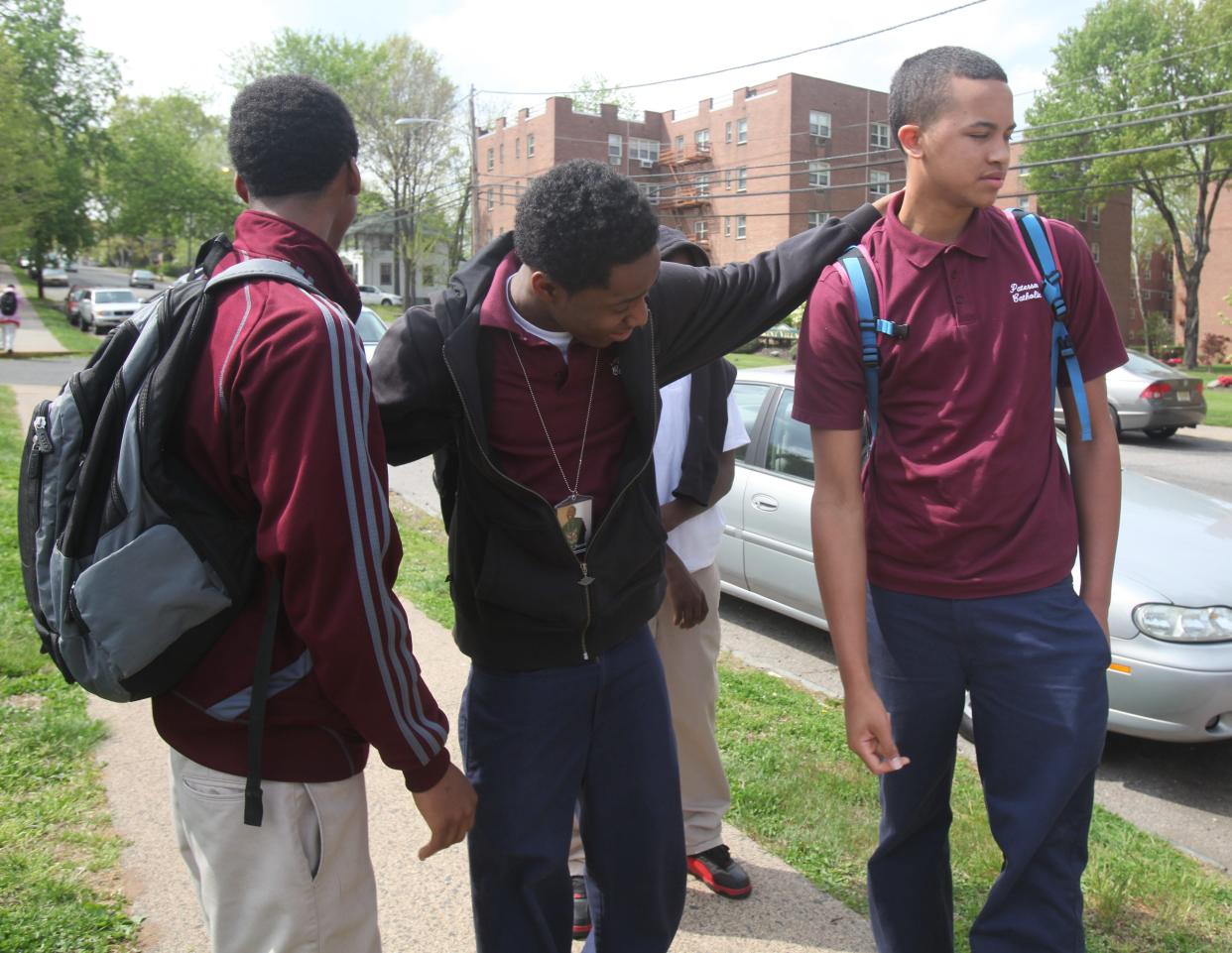 63776 --  Paterson, New Jersey -- April  21 , 2010  -- Students outside Paterson Catholic HS after school let out. They were told the school was closing this year. Sophomores James Freckleton, Ian Green and Kyle Anderson, a star guard on the basketball team, commiserate outside the school.  --  CHRIS PEDOTA / STAFF PHOTOGRAPHER