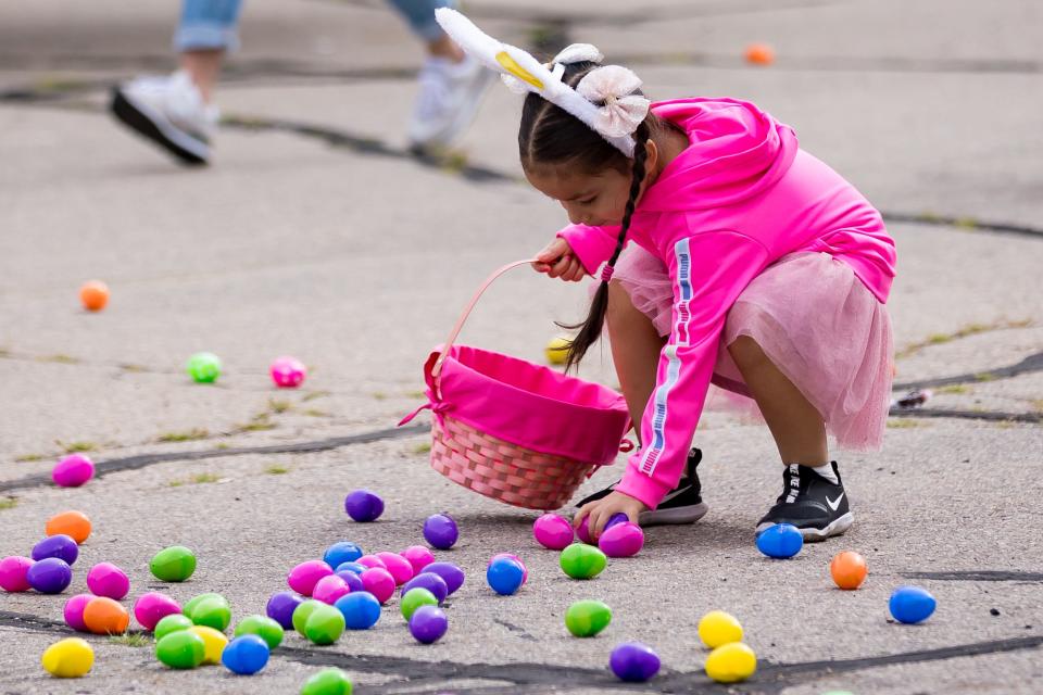 Kids put eggs in their baskets at the War Eagles Air Museum’s third annual Easter Egg Hunt Extravaganza on Saturday, March 23, 2024, with over 15,000 Easter eggs hidden around the museum hangar.