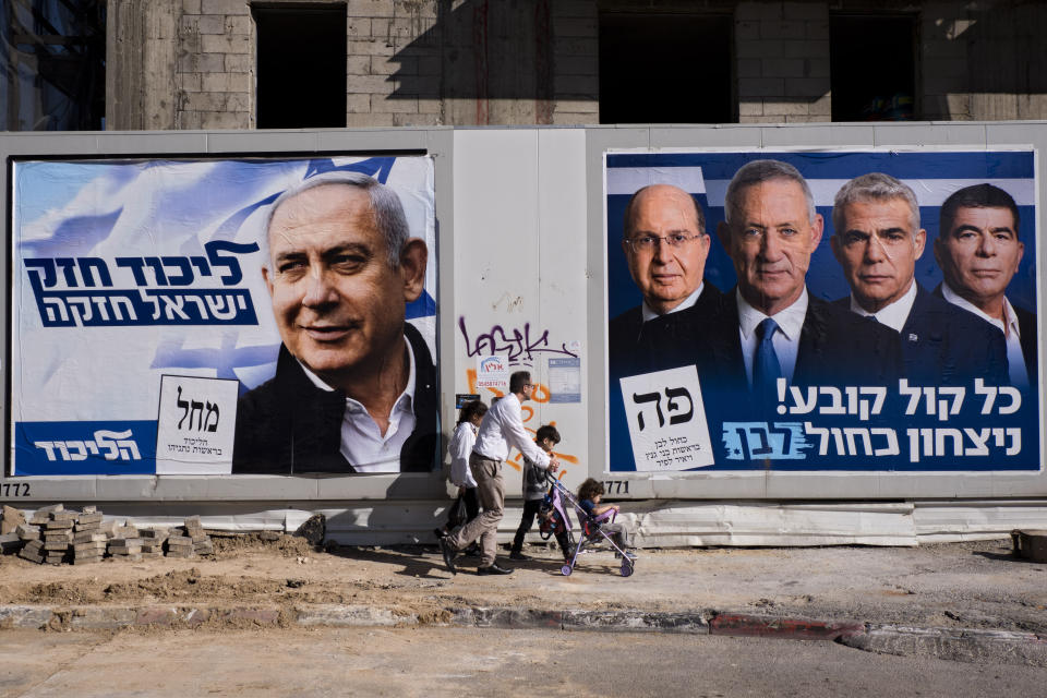Campaign billboards show Israeli Prime Minister Benjamin Netanyahu, left, alongside the Blue and White party leaders, from left, Moshe Ya’alon, Benny Gantz, Yair Lapid and Gabi Ashkenazi, in Tel Aviv on April 3. (Photo: Oded Balilty/AP)