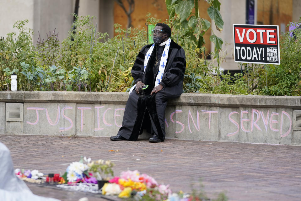 Rev. Raymond Johnson sits at Jefferson Square Park where a makeshift memorial has been set up in honor of Breonna Taylor, Thursday, Sept. 24, 2020, in Louisville, Ky. A grand jury on Wednesday, Sept. 23 indicted one officer on counts of wanton endangerment for firing into a home next to Taylor's with people in it, while declining to charge police officers for the fatal shooting of Taylor. (AP Photo/Darron Cummings)