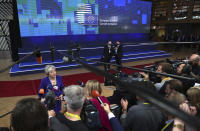 British Prime Minister Theresa May speaks with the media as she arrives for an EU summit at the Europa building in Brussels, Thursday, Oct. 18, 2018. EU leaders meet for a second day on Thursday to discuss migration, cybersecurity and to try and move ahead on stalled Brexit talks. (AP Photo/Francisco Seco)