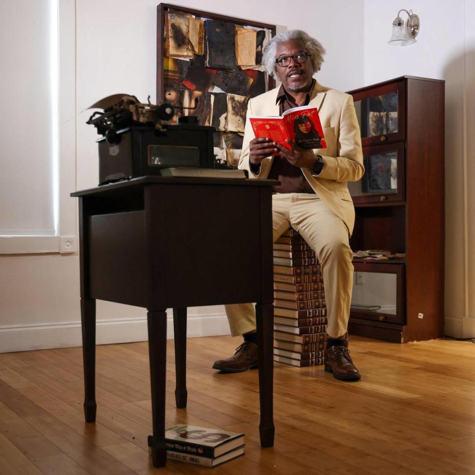 Artist Jessie Coleman, Jr. reads inside the D.A. Dorsey House in Overtown where the presentation of the exhibition “On the Ban Wagon: The Power of the Pen,” which delves into a pivotal chapter of history through the lens of banned books that is currently on display on Monday, March 11, 2024, in Miami, Florida. .