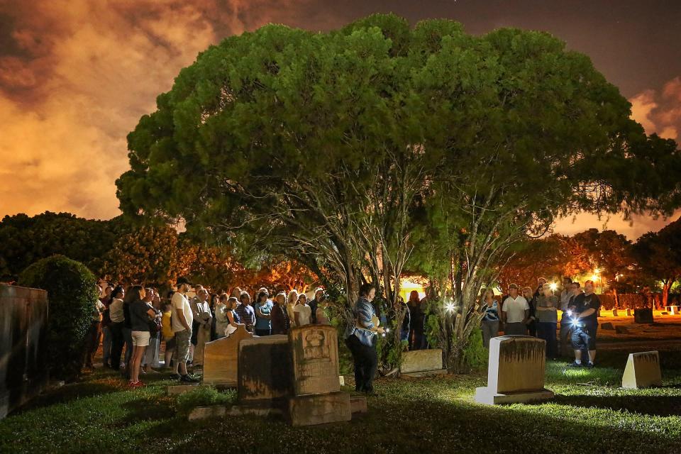 A large gathering of citizens take participate in a guided tour of historic Woodlawn Cemetery under the light of a full moon, December 5, 2014. The tour, which lasts approximately 90 minutes, reveals the stories of some of the area's oldest settlers that have been dug up by area historians.