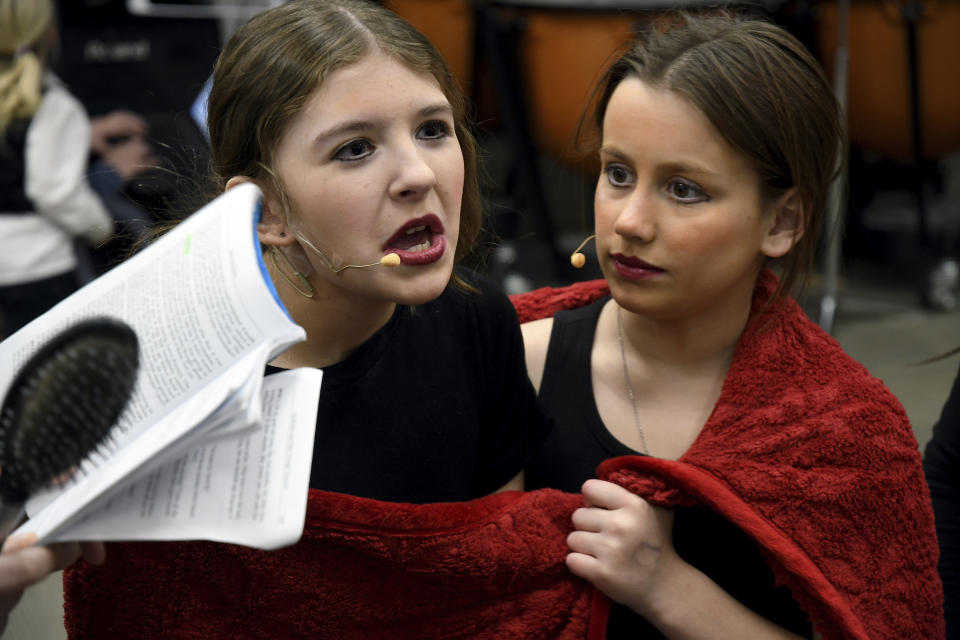 From left; Erica Biggs and Ember Bradley practice their lines before performing in “The Bullying Collection” at Wheatland High School in Wheatland, Wyoming on Friday, Jan. 12, 2024. School officials canceled the middle school play in part because it mentioned a gay character. The anti-bullying play was nonetheless performed under private sponsorship. (AP Photo/Thomas Peipert)