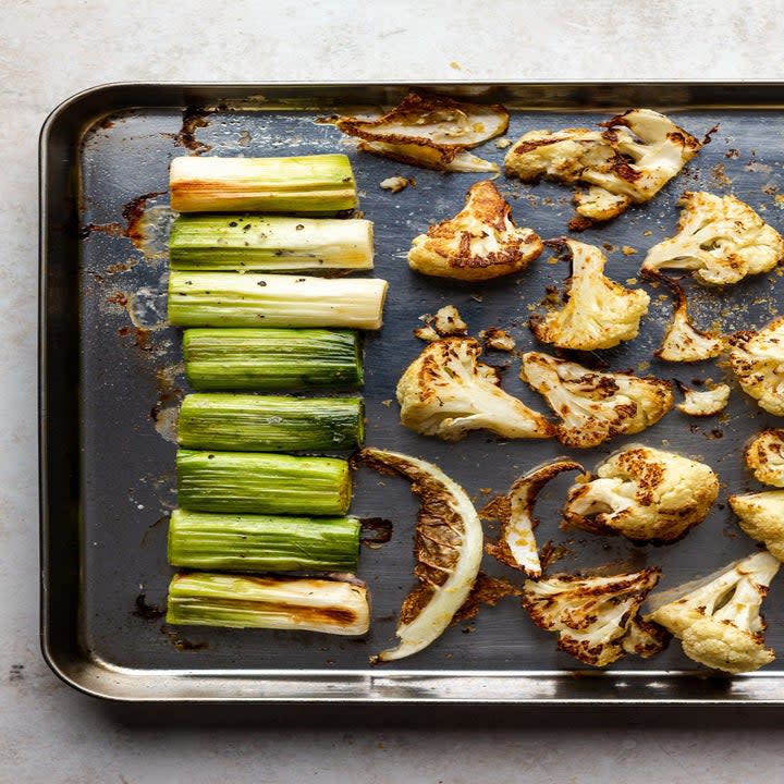 Leeks and cauliflower on a sheet pan.