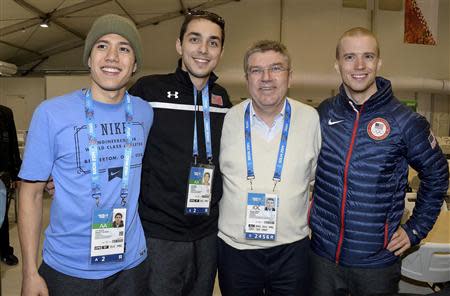 International Olympic Committee (IOC) President Thomas Bach (2nd R) poses with short track speed skaters J.R. Celski (L) and Kyle Carr (2nd L) and speed skater Patrick Meek (R) of the U.S. in the Coastal Athlete's Village at the Sochi 2014 Winter Olympics, February 1, 2014 . REUTERS/Pascal Le Segretain/Pool