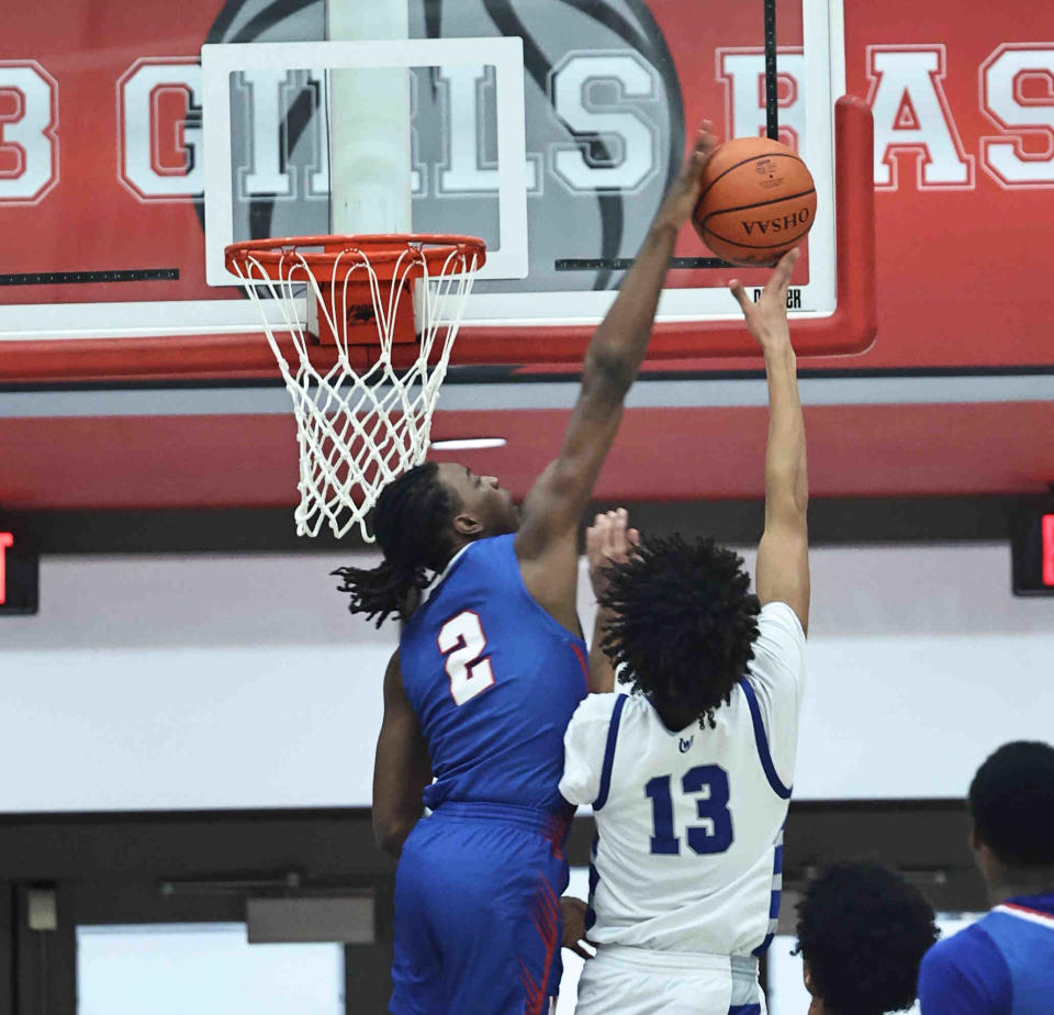 Woodward forward Ru Mills (2) blocks a shot by Wyoming forward Alex Lowe (13) during the Bulldogs' postseason loss to Wyoming Friday, March 1, 2024.