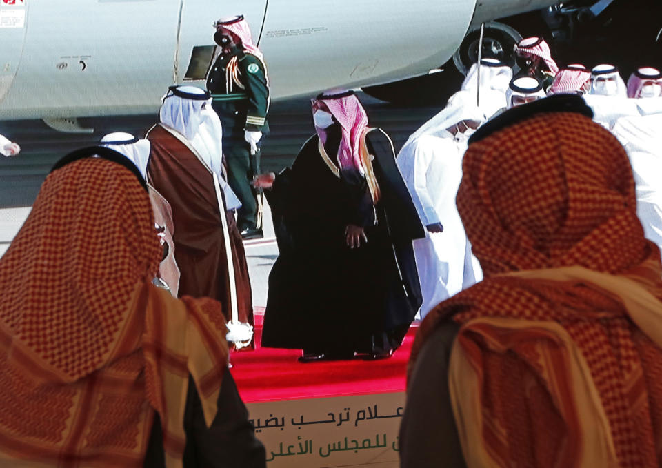 Saudi Crown Prince Mohammed bin Salman, center right, greets the Emir of Qatar Sheikh Tamim bin Hamad Al Thani, as he arrives at Al Ula airport, where the 41st Gulf Cooperation Council (GCC) take place in Saudi Arabia, Tuesday, Jan. 5, 2021. Al Thani's arrival in the kingdom’s ancient desert city of Al-Ula on Tuesday was broadcast live on Saudi TV. He was seen descending from his plane and being greeted with a hug by the Saudi crown prince. The diplomatic breakthrough comes after a final push by the outgoing Trump administration and fellow Gulf state Kuwait to mediate an end to the crisis. (AP Photo/Amr Nabil)