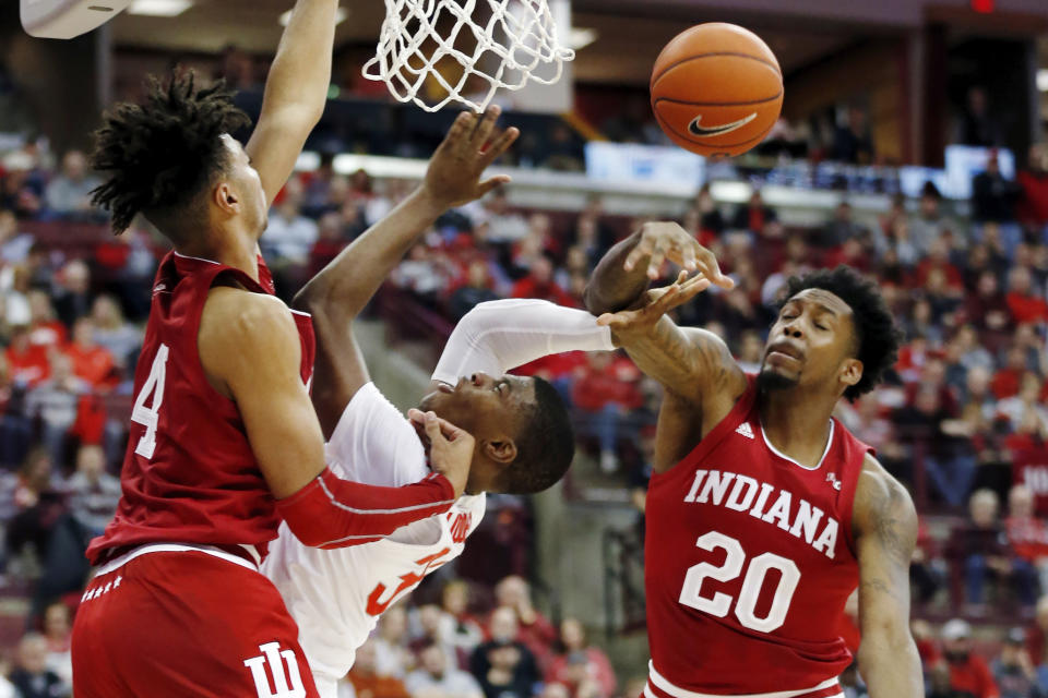 Indiana's De'Ron Davis, right, fouls Ohio State's E.J. Liddell as Trayce Jackson-Davis defends during the second half of an NCAA college basketball game Saturday, Feb. 1, 2020, in Columbus, Ohio. Ohio State beat Indiana 68-59. (AP Photo/Jay LaPrete)