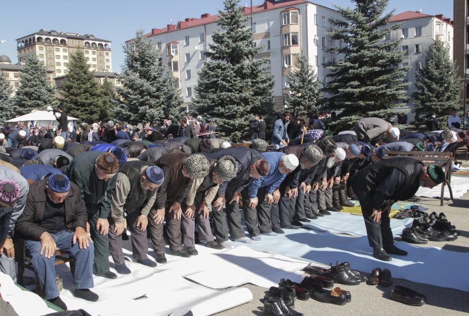 People pray during a protest against the new land swap deal agreed by the heads of the Russian regions of Ingushetia and Chechnya, in Ingushetia's capital Magas, Russia, Monday, Oct. 8, 2018. Ingushetia and the neighboring province of Chechnya last month signed a deal to exchange what they described as unpopulated plots of agricultural land, but the deal triggered massive protests in Ingushetia where it was seen by many as hurting Ingushetia’s interests. (AP Photo/Musa Sadulayev)