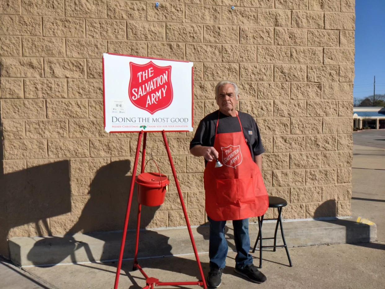 James Harrington, a volunteer with the Salvation Army, stands with a red kettle outside Walmart, 8301 Rogers Ave. in Fort Smith Dec. 22.