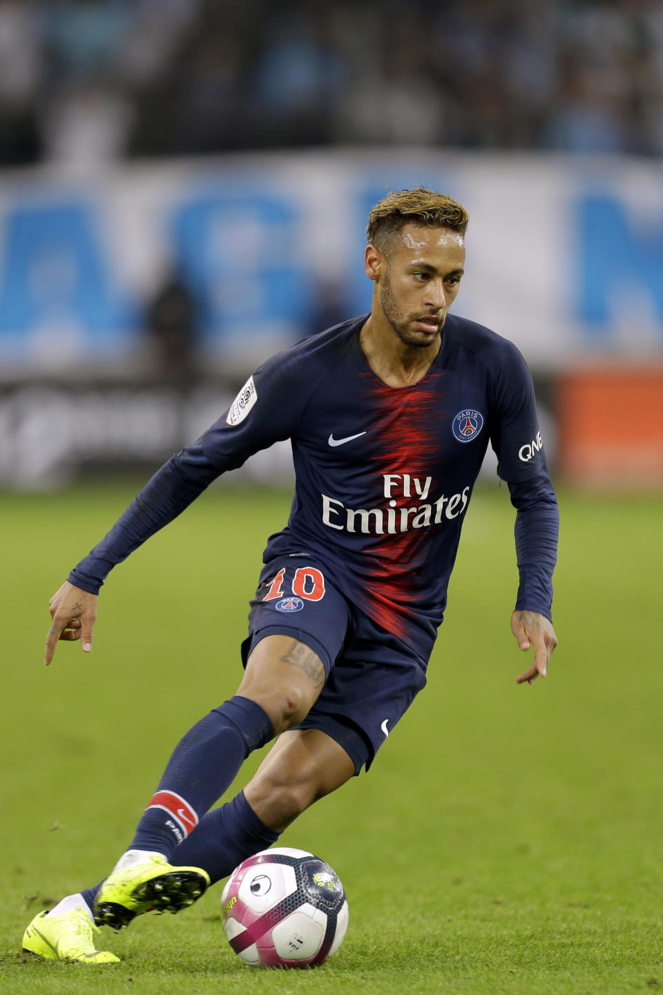 PSG's Neymar runs with the ball during the French League One soccer match between Paris-Saint-Germain and Marseille at the Velodrome Stadium in Marseille, France, Sunday, Oct. 28, 2018. (AP Photo/Claude Paris)