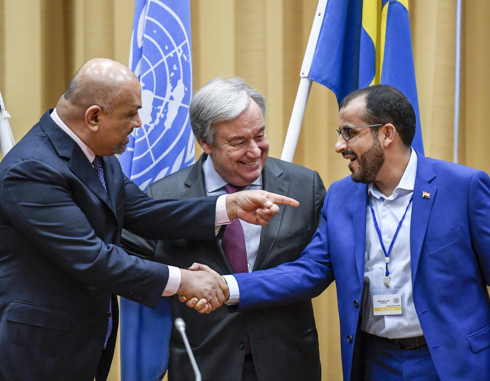 CORRECTS LAST NAME TO ABDULSALAM, NOT AMDUSALEM - Head of delegation for rebel forces known as Houthis, Mohammed Abdulsalam, right, and Yemen Foreign Minister Khaled al-Yaman, left, shake hands together with UN Secretary Geleral Antonio Guterres, during the Yemen peace talks closing press conference at the Johannesberg castle in Rimbo north of Stockholm, Sweden, Thurday Dec. 13, 2018. The United Nations secretary general on Thursday announced that Yemen's warring sides have agreed after week-long peace talks in Sweden to a province-wide cease-fire in Hodeida. (Pontus Lundahl/TT News agency via AP)