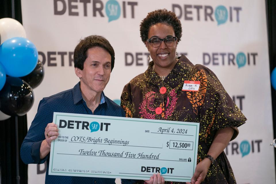 Mitch Albom of SAY Detroit hands Aisha Morrell-Ferguson the Chief Development Officer of COTS Bright Beginnings a $12,500 check on Thursday, April 4, 2024 at the Start Up Nation event space in Birmingham.