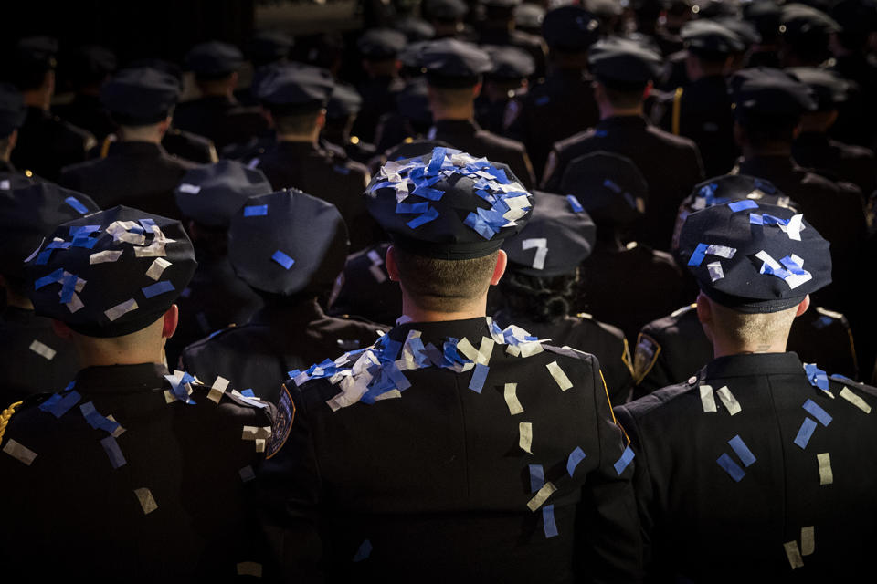 Confetti on caps and uniforms of new police graduates