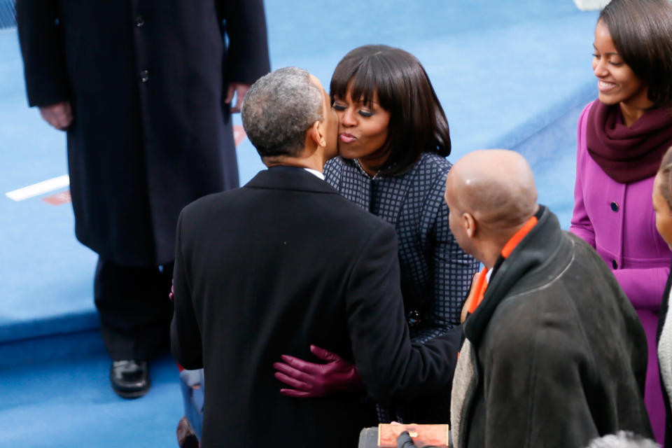 U.S. President Barack Obama kisses First lady Michelle Obama during the presidential inauguration on the West Front of the U.S. Capitol January 21, 2013 in Washington, DC. Barack Obama was re-elected for a second term as President of the United States. (Photo by Rob Carr/Getty Images)