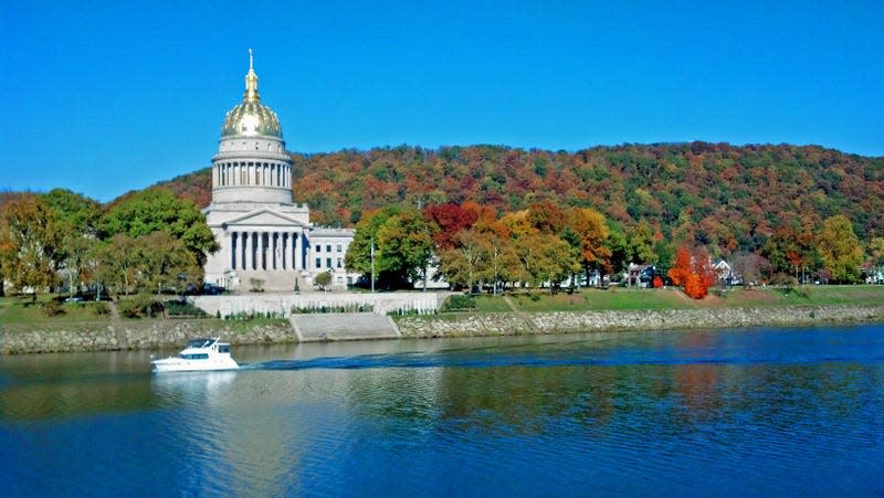 The beautiful capitol building in Charleston, West Virginia as seen across the Kanawha River. Taken in the fall, this picture shows the colorful hills behind the capitol.