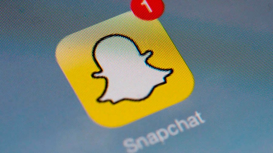 <em>The logo of mobile app “Snapchat” is displayed on a tablet on January 2, 2014 in Paris. (Photo by LIONEL BONAVENTURE/AFP via Getty Images)</em>