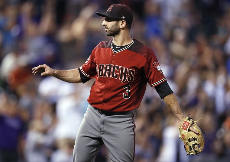 Arizona Diamondbacks infielder-turned-relief-pitcher Daniel Descalso calls for a new ball after giving up a three-run home run to Colorado Rockies’ Carlos Gonzalez. (AP)