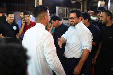 Muntazer al-Zaidi, a candidate on the Sairun list, speaks with people in the Sadr City district of Baghdad, Iraq May 10, 2018. Picture taken May 10, 2018. REUTERS/Thaier al-Sudani