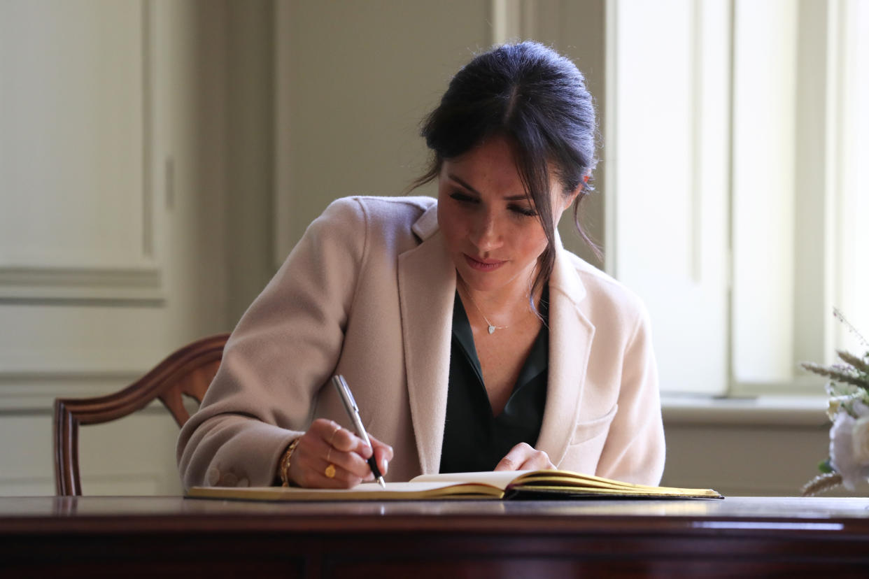 Meghan, Duchess of Sussex signs the visitors book during an engagement at Edes House, in Chichester, Britain October 3, 2018. Daniel Leal-Olivas/pool via Reuters