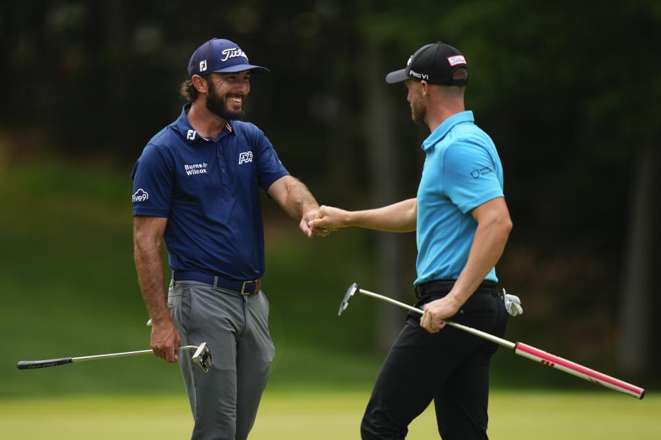 Max Homa, left, fist-bumps Wyndham Clark, right, after their putts on the 10th hole during the second round of the Travelers Championship golf tournament at TPC River Highlands, Friday, June 23, 2023, in Cromwell, Conn. (AP Photo/Frank Franklin II)