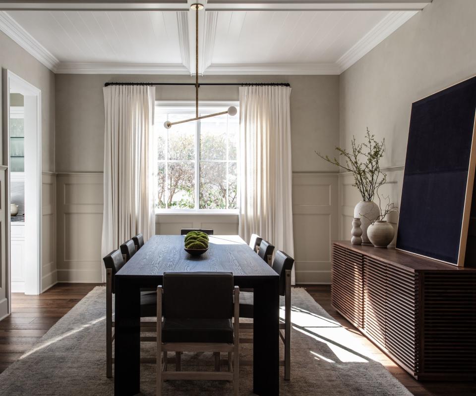 Dining room with sideboard on the right and artwork leaning