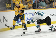 Nashville Predators defenseman Alexandre Carrier (45) passes the puck past San Jose Sharks center Andrew Cogliano (11) in the first period of an NHL hockey game Tuesday, Oct. 26, 2021, in Nashville, Tenn. (AP Photo/Mark Humphrey)