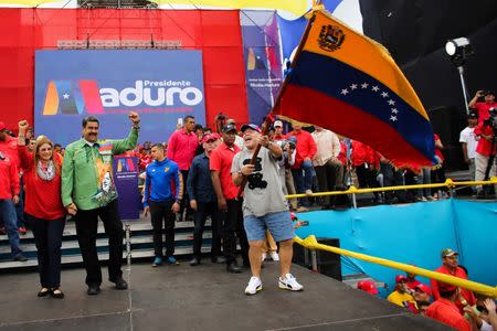 Venezuela's President Nicolas Maduro, his wife Cilia Flores and former Argentinian soccer player Diego Maradona greet supporters during a campaign rally in Caracas, Venezuela May 17, 2018. Miraflores Palace/Handout via REUTERS