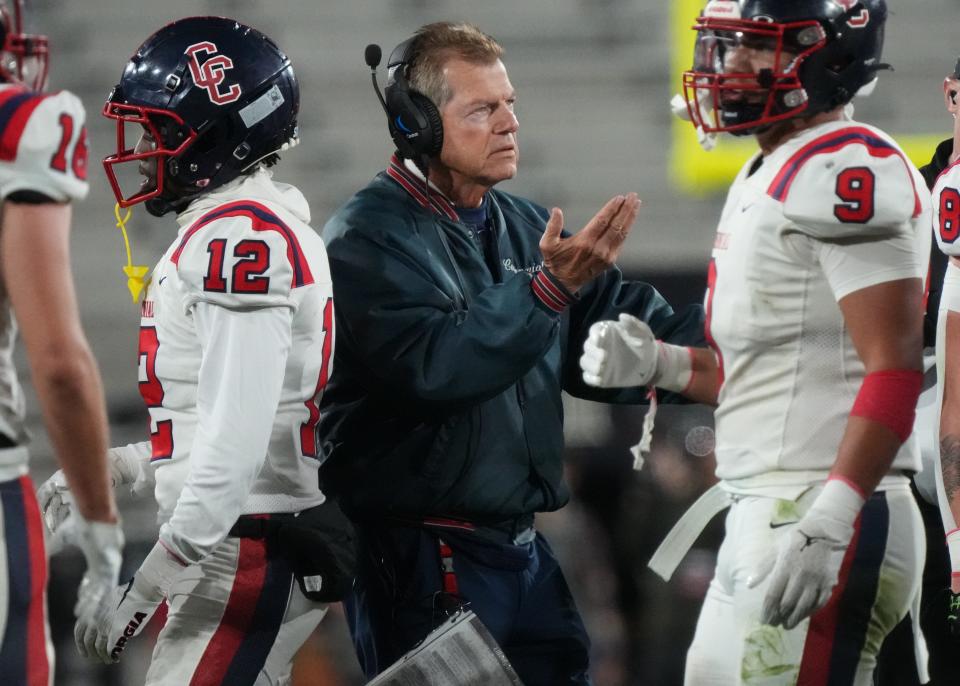 Centennial head coach Richard Taylor talks to his team during a timeout against Liberty during their Open Division State Championship game at Mountain America Stadium in Tempe on Dec. 2, 2023.