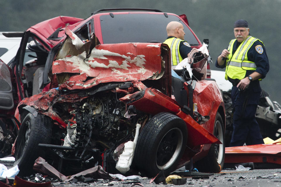 Officials investigate the scene of a multiple vehicle accident where 6 people were killed on the westbound Pomona Freeway in Diamond Bar, Calif. on Sunday morning, Feb. 9, 2013. Authorities say a wrong-way driver caused the pre-dawn crash that left six people dead. (AP Photo/San Gabriel Valley Tribune,Watchara Phomicinda) MAGS OUT, NO SALES MANDATORY CREDIT