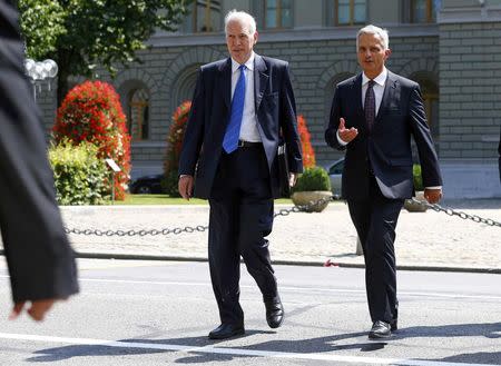 Swiss Foreign Minister Didier Burkhalter (R) and newly appointed EU negotiator Jacques de Watteville arrive for a news conference in Bern, Switzerland August 12, 2015. REUTERS/Ruben Sprich