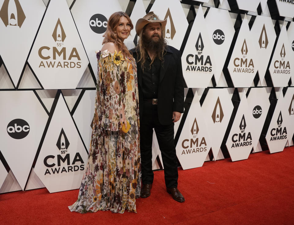 Chris Stapleton, right, and Morgane Stapleton arrive at the 55th annual CMA Awards on Wednesday, Nov. 10, 2021, at the Bridgestone Arena in Nashville, Tenn. (AP Photo/Ed Rode)