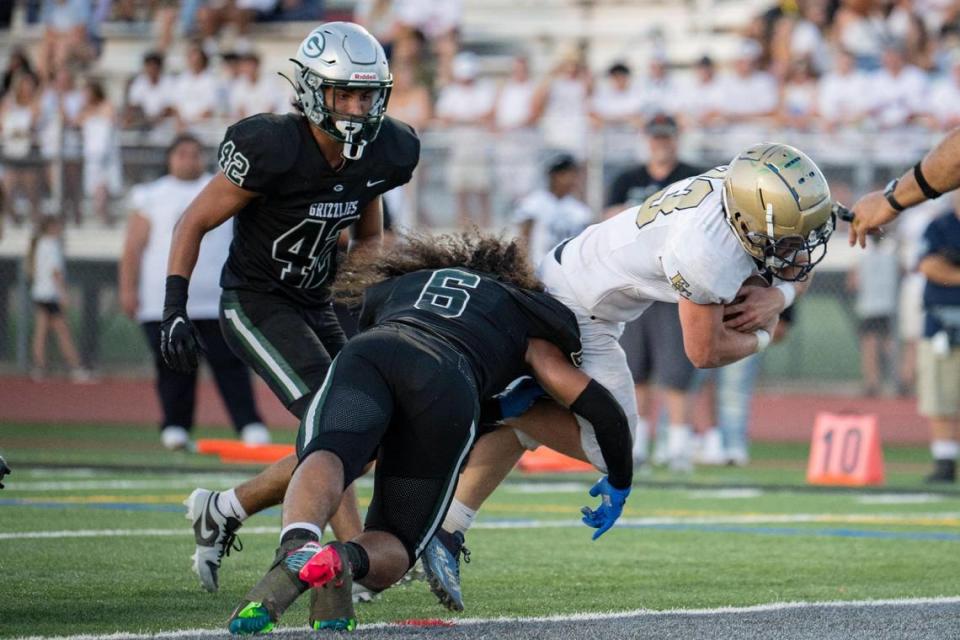 Elk Grove Thundering Herd fullback Ethan Scott (23) dives for the touchdown during the first half of a game against Elk Grove at Granite Bay High School on Friday.