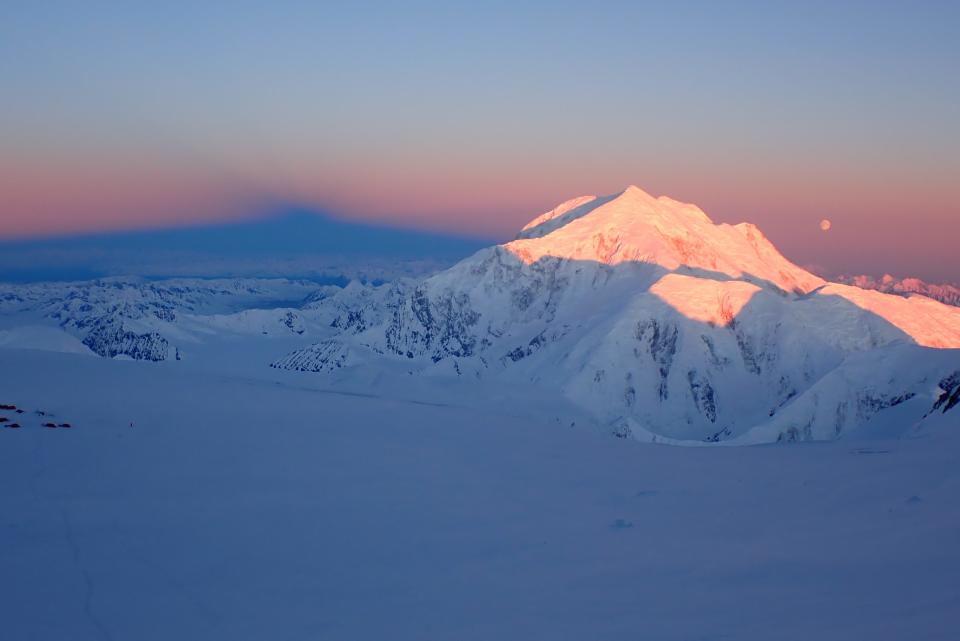 Early morning sunrise on the Alaska Range. Denali's "summit shadow" (left) casting over the Kahiltna and Mt. Foraker (right), North America's sixth tallest peak.