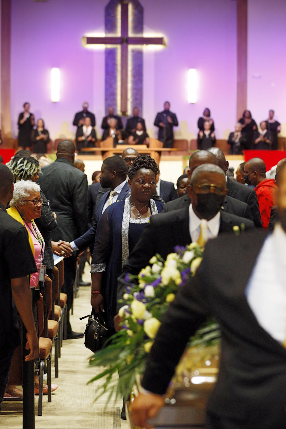 Caroline Ouko walks behind her son's casket as the celebration of life for Irvo Otieno comes to an end at First Baptist Church in North Chesterfield, Va., on Wednesday, March 29, 2023. Irvo Otieno, a 28-year-old Black man, died after he was pinned to the floor by seven sheriff's deputies and several others while he was being admitted to a mental hospital. (Eva Russo/Richmond Times-Dispatch via AP)