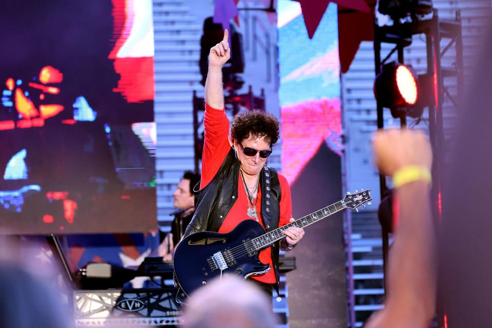 Lead guitarist Neal Schon holds up his arm during a solo as Journey headlines the show at the Stadium of Fire in Provo on Saturday, July 1, 2023. | Scott G Winterton, Deseret News