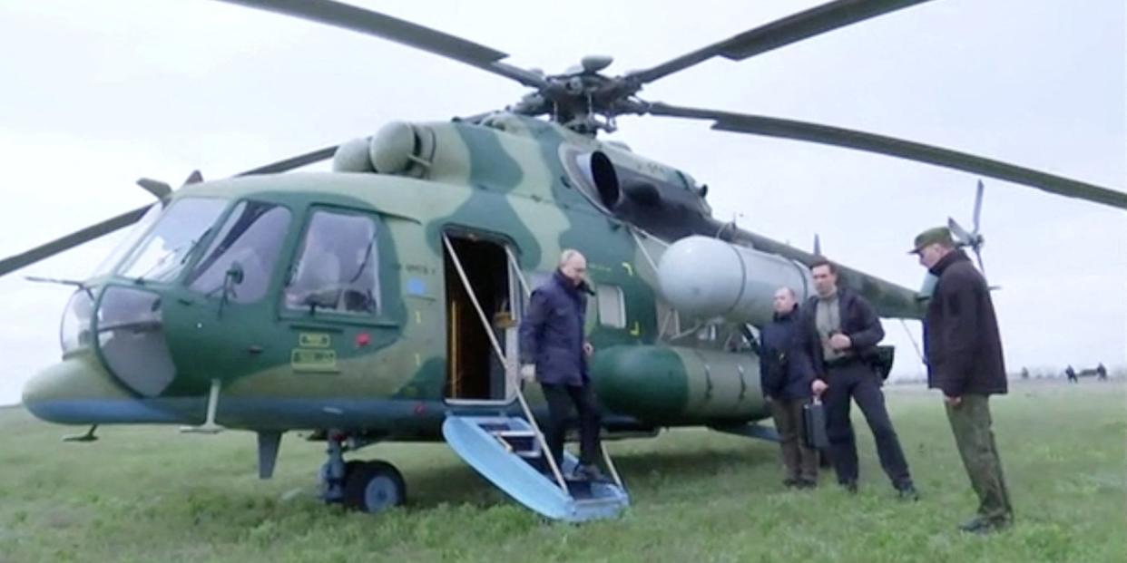 Russian President Vladimir Putin disembarks a helicopter as he visits the headquarters of the "Dnieper" army group in the Kherson Region, Russian-controlled Ukraine, in this still image taken from handout video released on April 18, 2023.