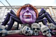 <p>A carnival float depicting German chancellor Angela Merkel as a black widow sitting over the bones and sculls of German politicians is pictured during a carnival parade on Rose Monday on Feb. 12, 2018 in Duesseldorf, western Germany. (Photo: Patrik Stollarz/Getty Images) </p>