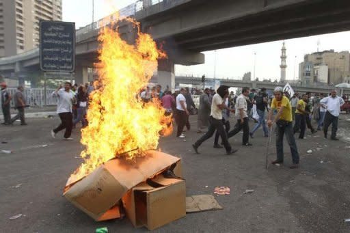 Egyptian protesters set cardboard boxes on fire during an anti-military demonstration outside the defense ministry in Cairo on May 4. Egypt's military prosecution has ordered 179 people be detained over deadly clashes between troops and anti-military protesters in Cairo, a military source told AFP