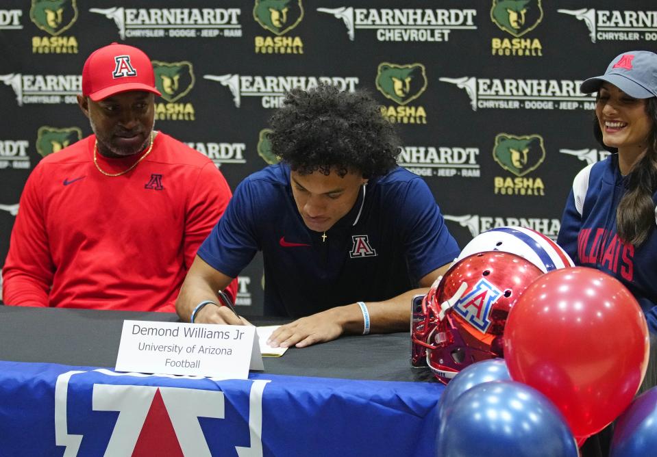 Basha quarterback Demond Williams signs his letter of intent to play for University of Arizona during the NLI signing at Basha High School in Chandler on Dec. 20, 2023.