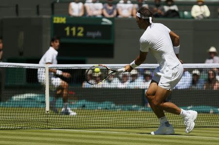 Rafael Nadal of Spain hits a volley during his match against Thomaz Bellucci of Brazil at the Wimbledon Tennis Championships in London, June 30, 2015. REUTERS/Stefan Wermuth