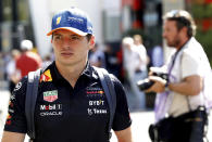 Red Bull driver Max Verstappen of the Netherlands, left, walks in the paddock ahead of the Formula One Grand Prix at the Spa-Francorchamps racetrack in Spa, Belgium, Thursday, Aug. 25, 2022. The Belgian Formula One Grand Prix will take place on Sunday. (AP Photo/Olivier Matthys)
