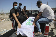 Mourners escort the flag-draped coffin of activist Reham Yacoub during her funeral procession in Basra, Iraq, Thursday, Aug. 20, 2020. Activist Reham Yacoub was gunned down in the southern Iraqi province of Basra on Wednesday by unidentified gunmen, a security official and human rights watcher said, marking the second such killing in the span of a week. The official spoke on condition of anonymity in line with regulations. (AP Photo/Nabil al-Jurani)