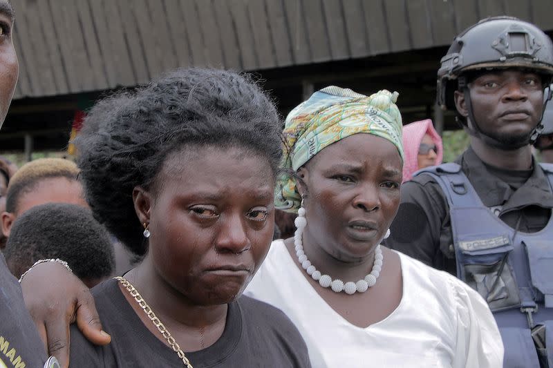 Manyi Tita mourns her 10-year-old daughter who was killed by unidentified assailants in a classroom of a secondary school during a mass funeral in Kumba