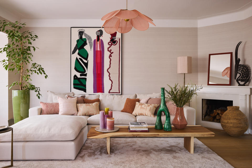 A living room with pink lights and light pink walls