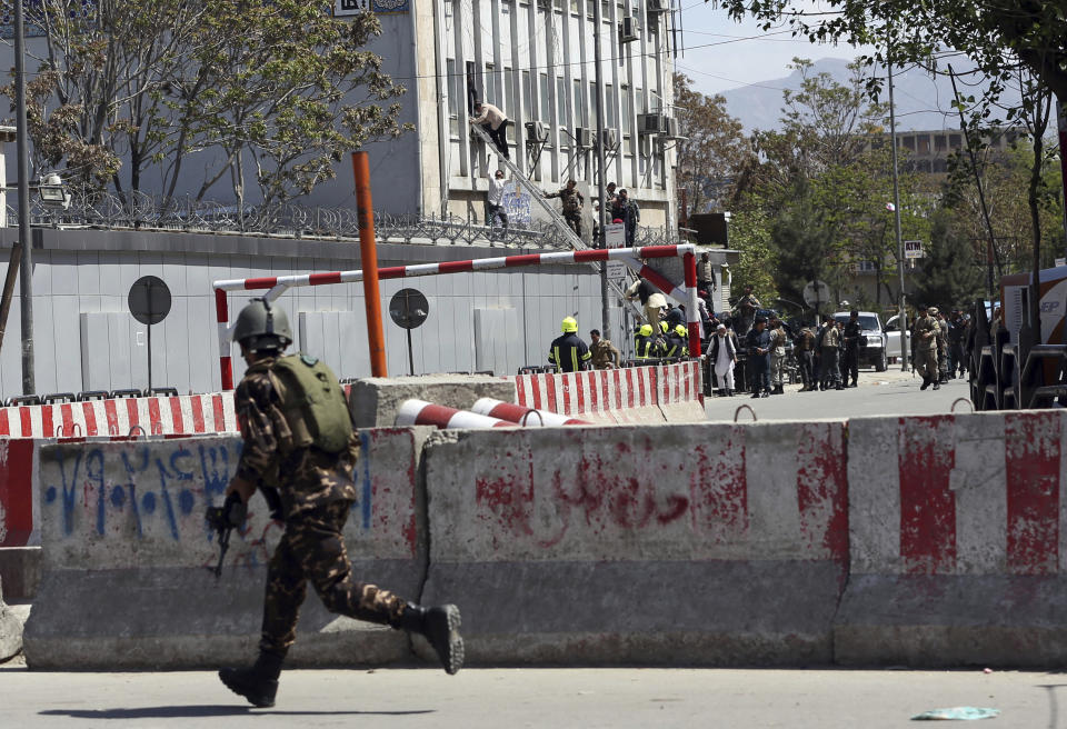 An Afghan Security personnel arrives on the perimeter outside the Telecommunication Ministry during a gunfight with insurgents in Kabul, Afghanistan, Saturday, April 20, 2019. Afghan officials say an explosion has rocked the telecommunications ministry in the capital city of Kabul. Nasart Rahimi, a spokesman for the interior ministry, said Saturday the blast occurred during a shootout with security forces. (AP Photo/Rahmat Gul)