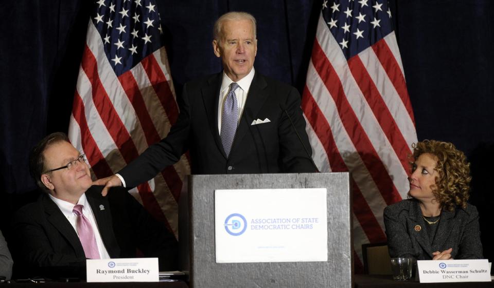 Vice President Biden, flanked by President of the Association of State Democratic Chairs Raymond Buckley, left, and Democratic National Committee Chair Rep. Debbie Wasserman-Schultz, D-Fla, speaks at the Association of State Democratic Chairs meeting in Washington, Thursday, Feb. 27, 2014. (AP Photo/Susan Walsh)