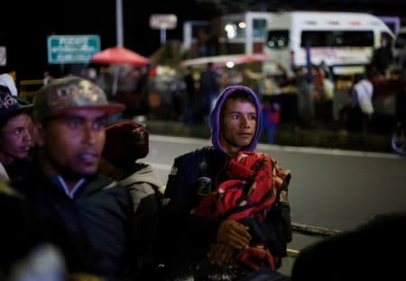 Venezuelans gather to cross into Ecuador from Colombia, as new visa restrictions from the Ecuadorian government took effect, at Rumichaca border bridge in Tulcan